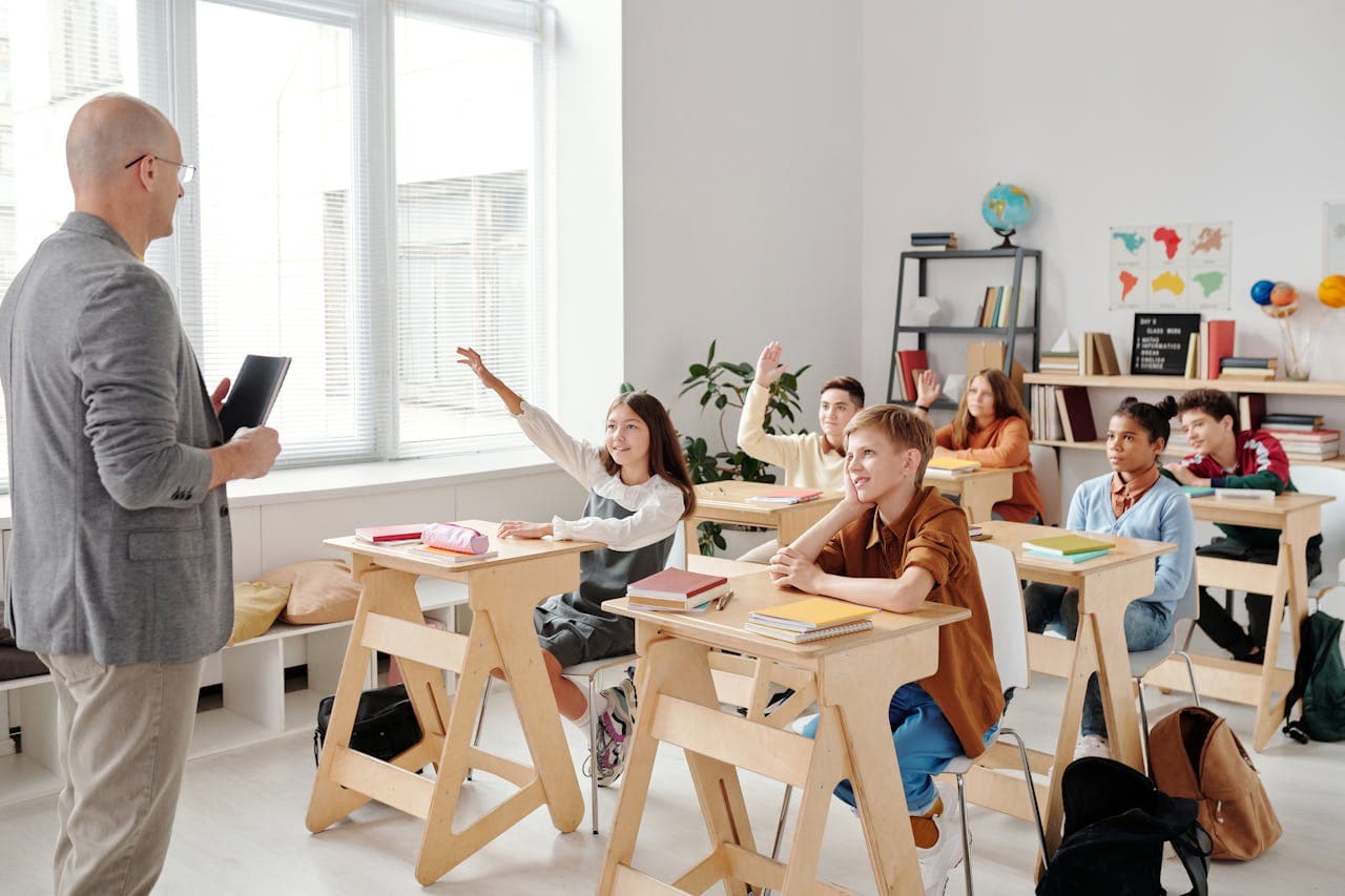 students at school with their notes in a classroom.